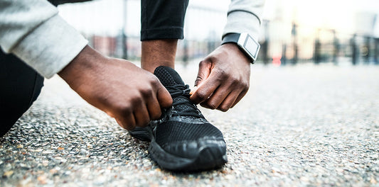 man tying his black shoe