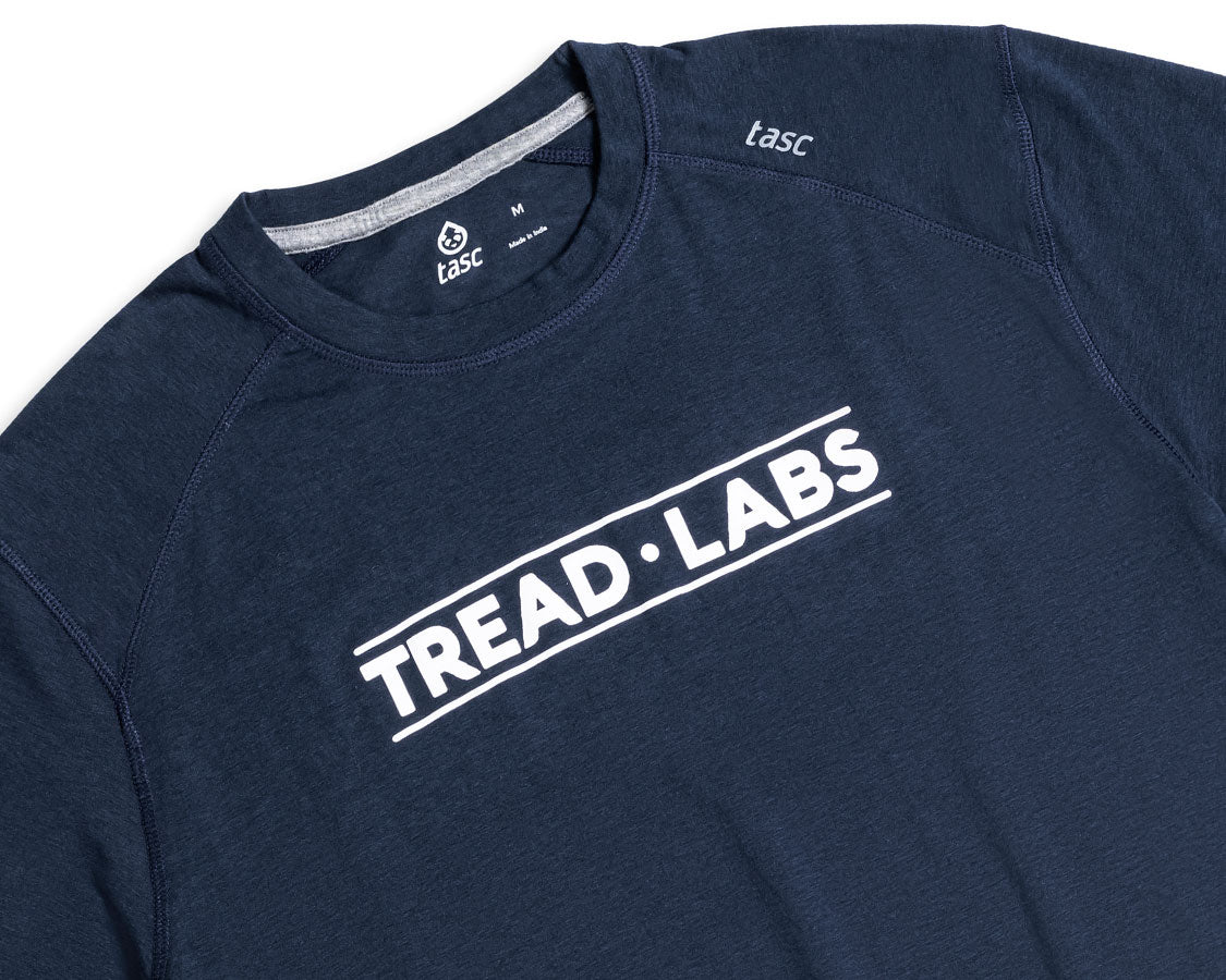 Detail of men's dark blue t-shirt with Tread Labs logo on the chest