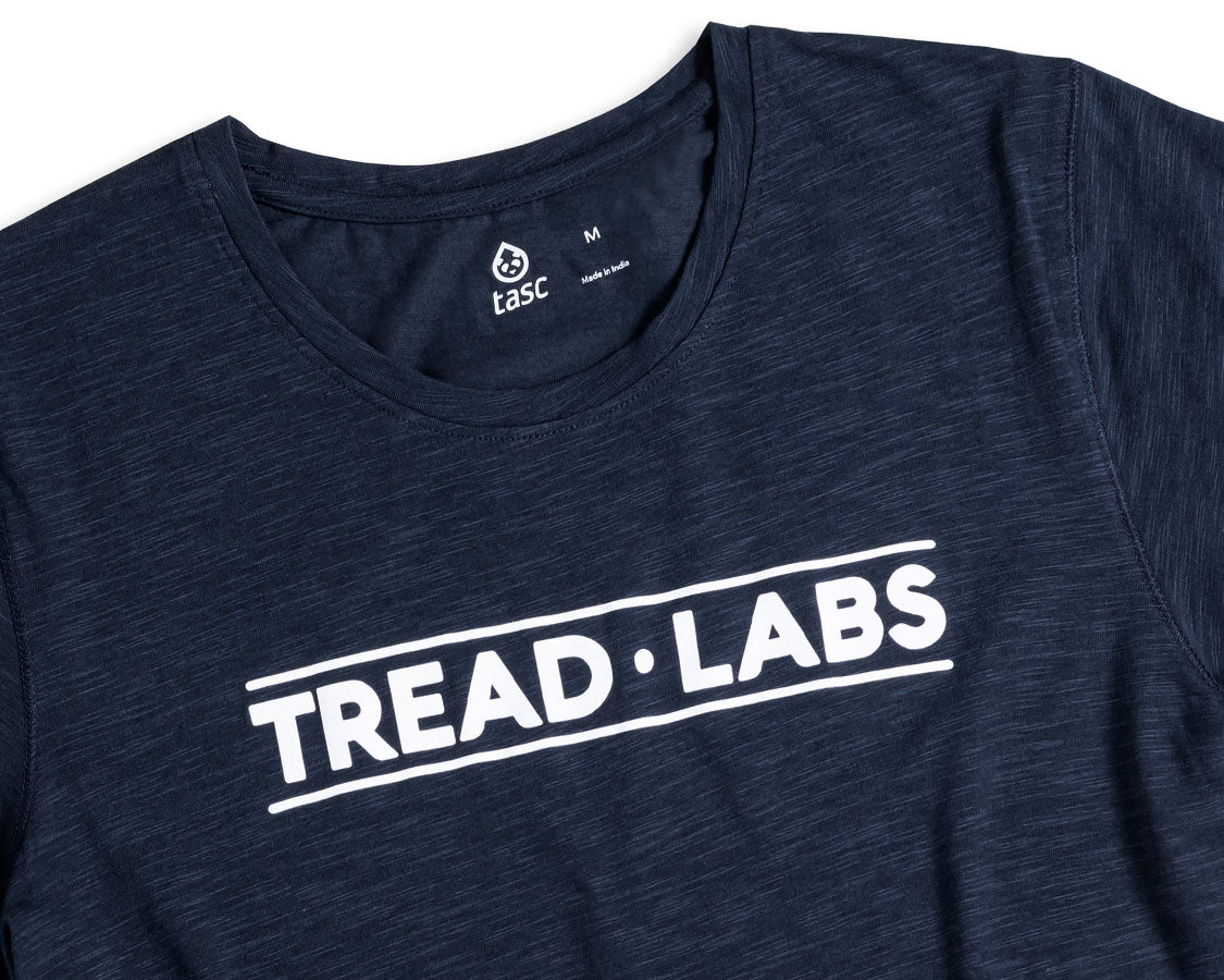 Detail of women's dark blue t-shirt with Tread Labs logo on chest